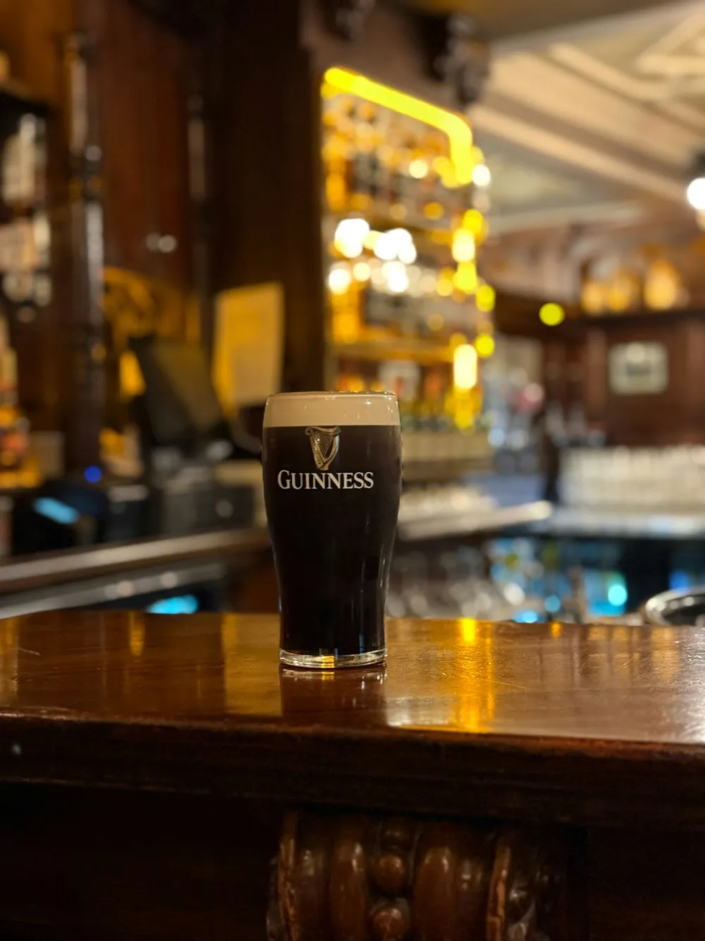 A perfect pint of stout on the bar counter