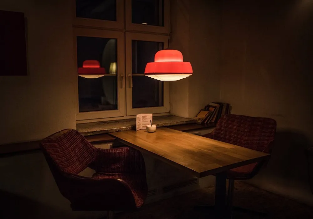 Intimate booth with wooden table and warm lamp light